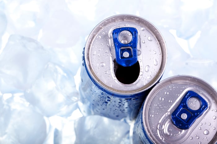 Two energy drink cans in ice. 