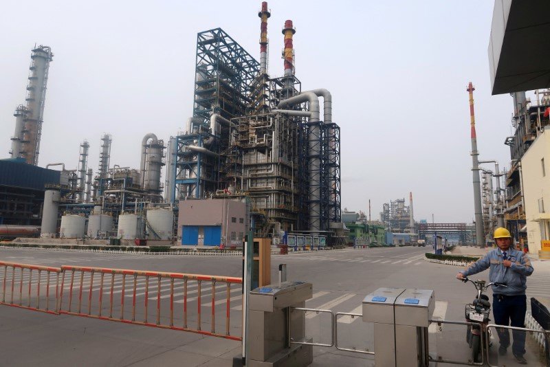 © Reuters. FILE PHOTO: A man is seen at an exit of the refinery plants of Chambroad Petrochemicals in Binzhou, Shandong province, China October 24, 2019. Picture taken October 24, 2019. REUTERS/Stringer/File Photo