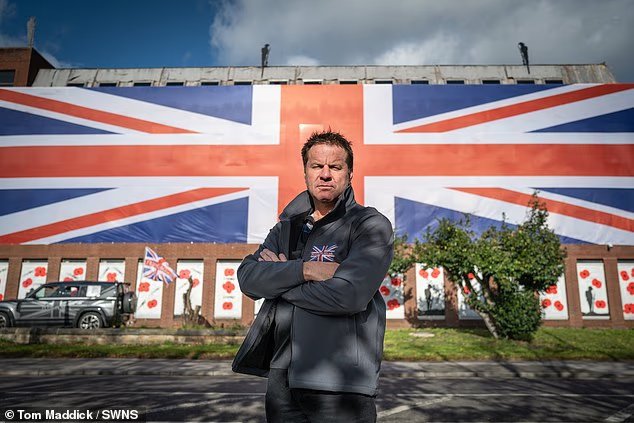 Property boss drapes enormous 100ft Union flag across former council HQ after officials told him to remove smaller version